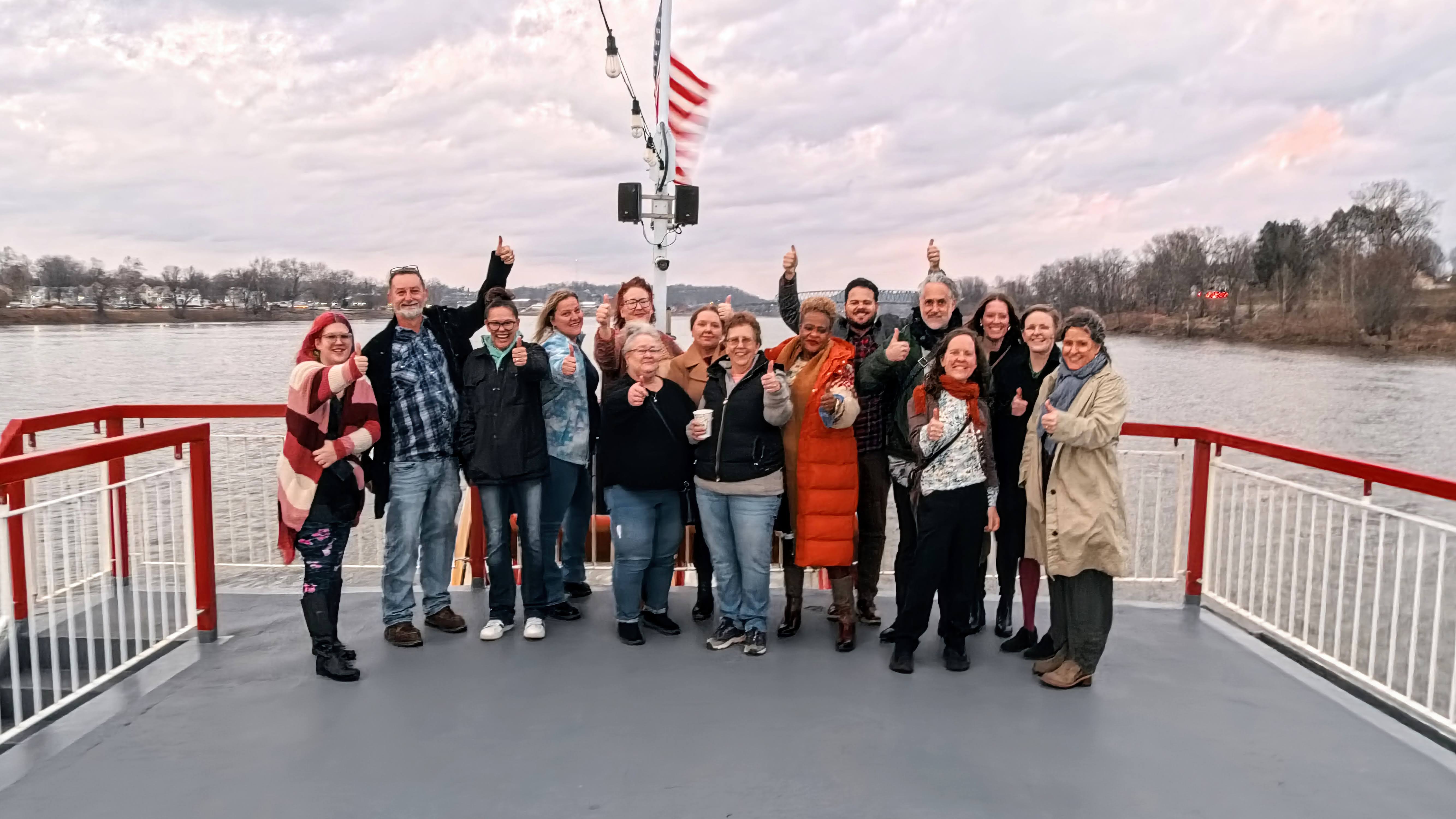 Amy with a group of community members on a riverboat deck.